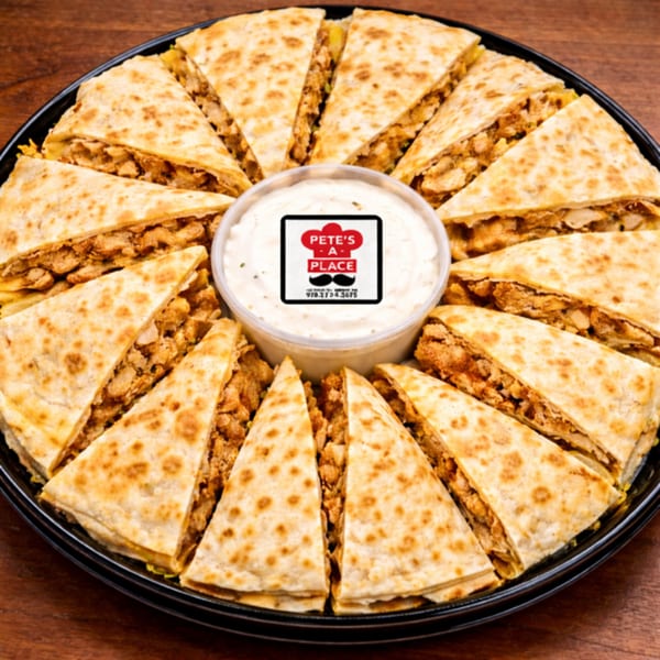 A platter of Pete's-A-Place quesadilla wedges with chicken and cheese, surrounding a cup of dipping sauce.